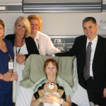 SLU Hospital nurse Cyndi Johnson, RN, is surrounded by colleagues who cared for her during her recent  heart surgery