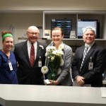 Morgan Harris, RN, Phil Sowa, CEO and Russ Schroeder, Chief Nursing Officer, flank SLU Hospital Daisy Award Winner Molly Porter, RN