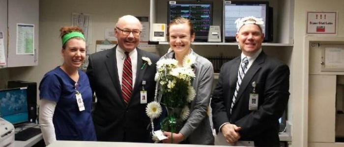 Morgan Harris, RN, Phil Sowa, CEO and Russ Schroeder, Chief Nursing Officer, flank SLU Hospital Daisy Award Winner Molly Porter, RN